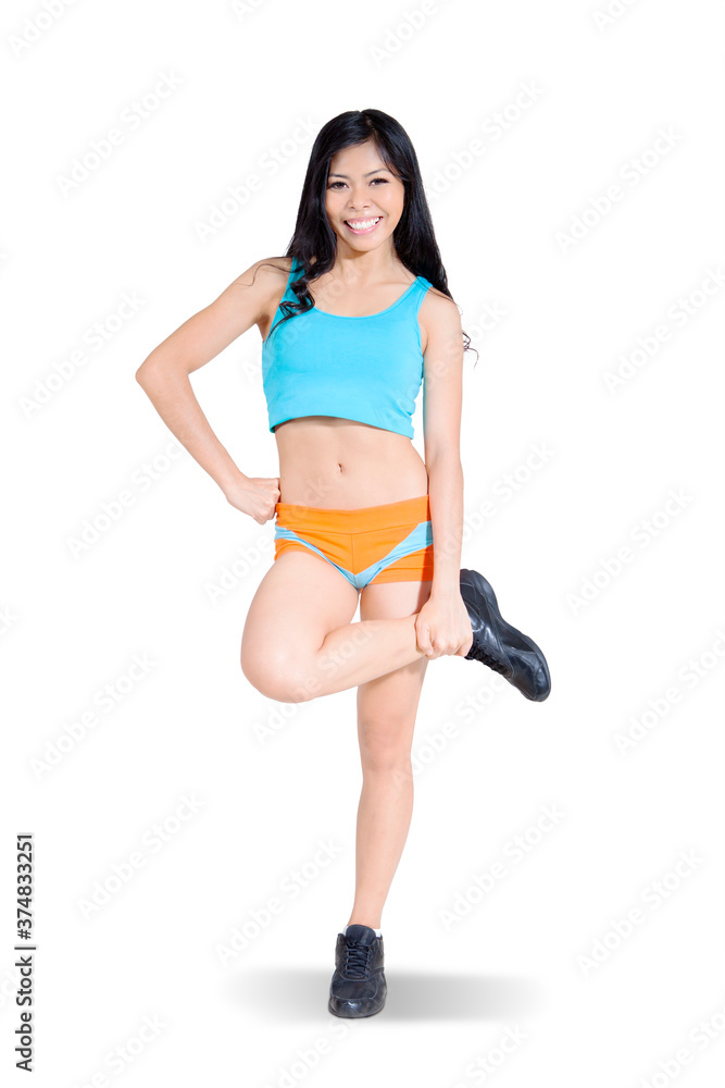 Asian woman stretching her legs on studio Asian woman stretching her legs on studio