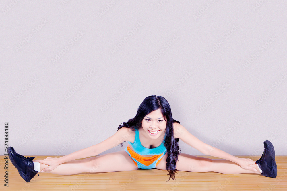 Beautiful woman smile while stretches her hamstring Beautiful woman smile while stretches her hamstring
