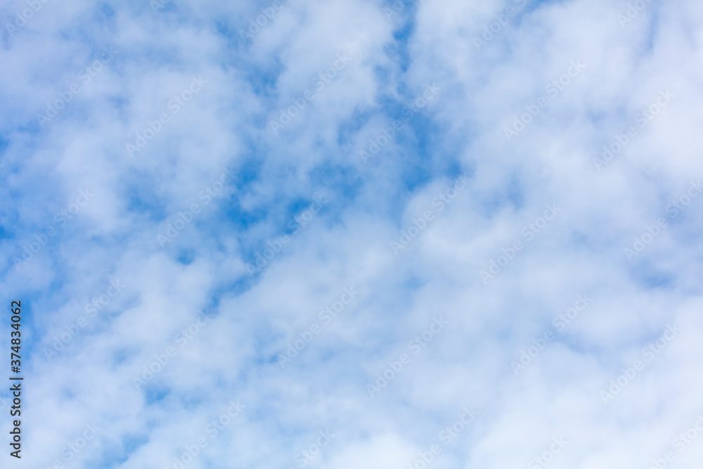 Obraz premium White clouds on a blue sky as background