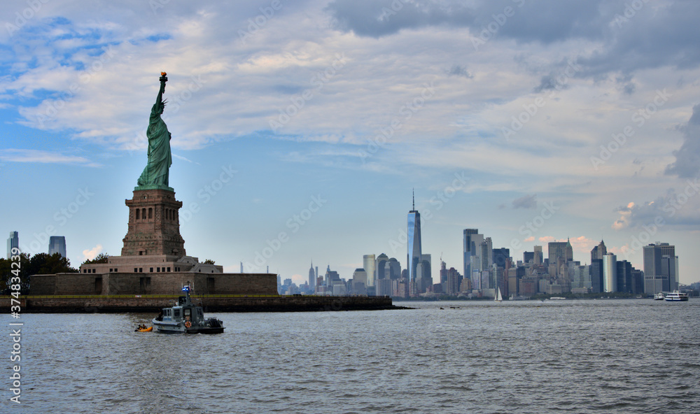 A picture of Lady Liberty with New York city in the background.