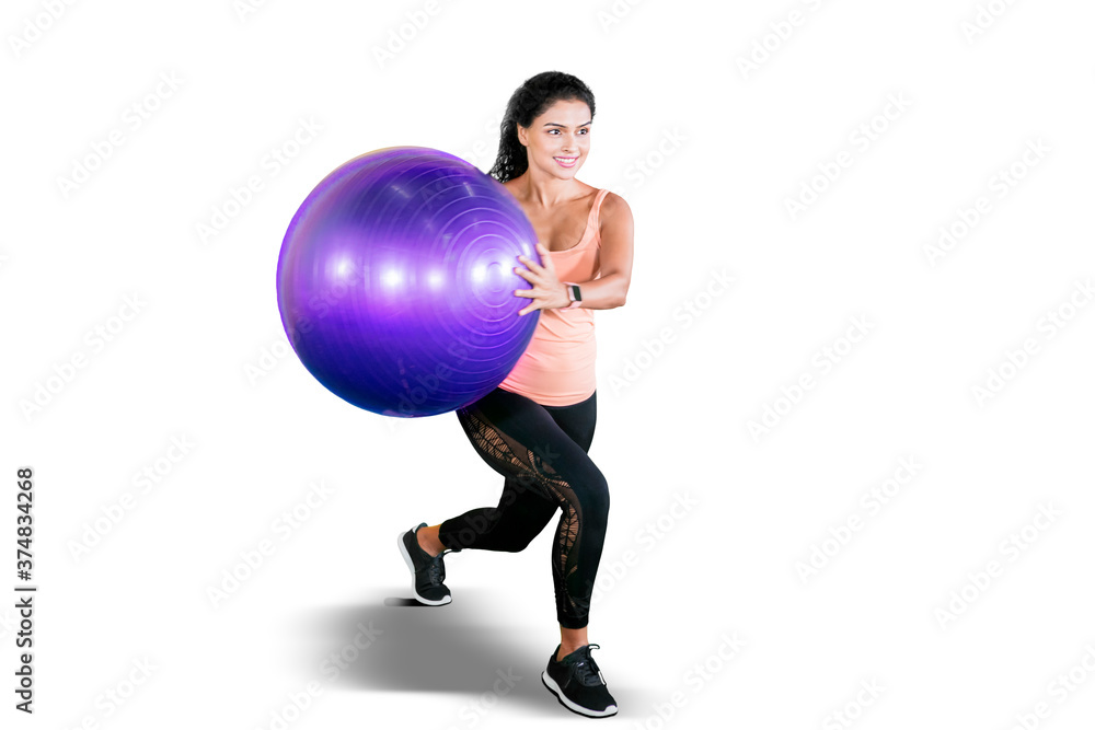 Curly hair woman exercise with yoga ball on studio Curly hair woman exercise with yoga ball on studio