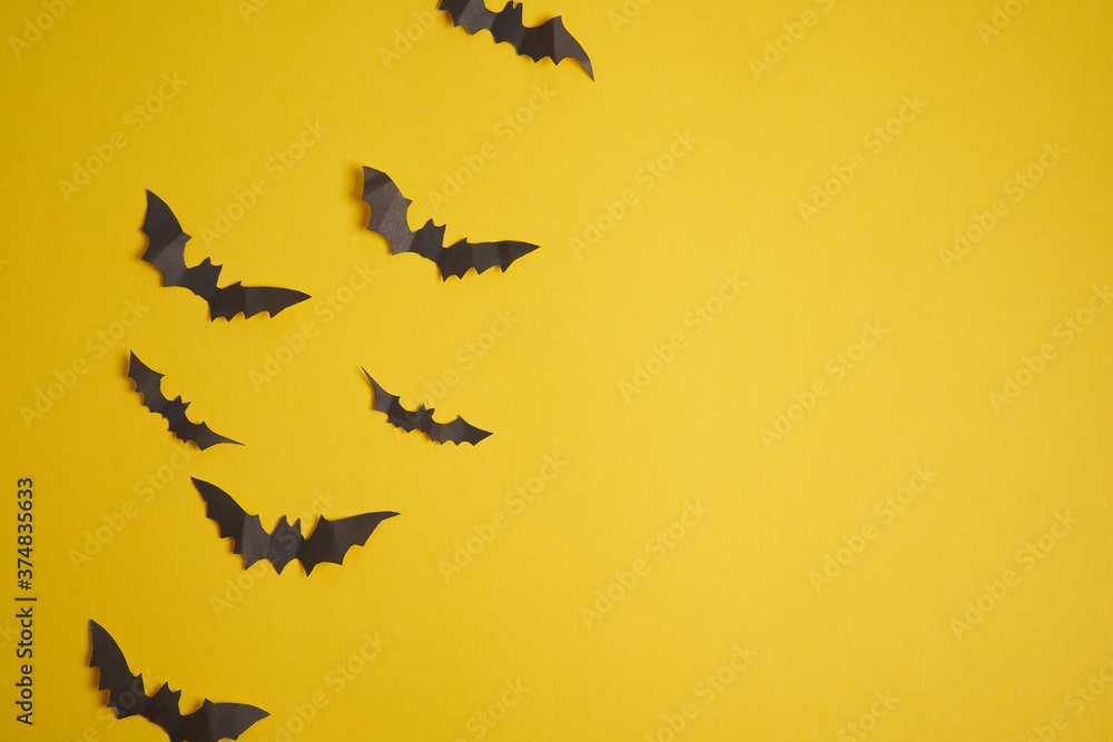Halloween decoration concept black paper bats yellow cardboard background Halloween decoration concept black paper bats yellow cardboard background