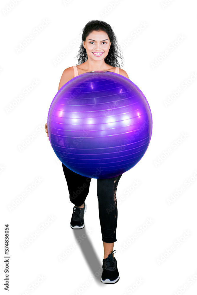 Unknown woman exercise with a yoga ball on studio Unknown woman exercise with a yoga ball on studio