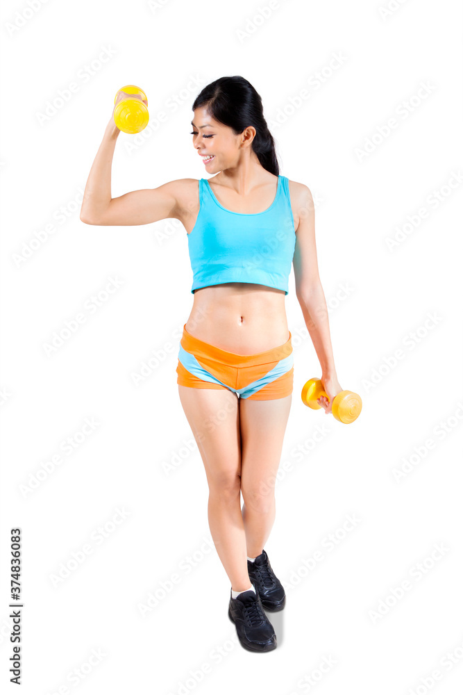 Woman look at biceps while exercise with dumbbells Woman look at biceps while exercise with dumbbells