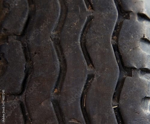 Worn old black rubber tire from a truck, close-up.