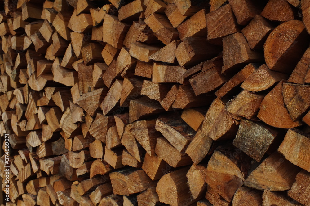 background macro image of round logs of brown color for a fireplace background macro image of round logs of brown color for a fireplace
