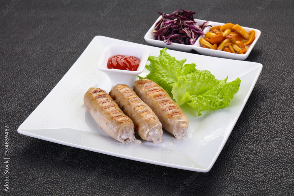 Grilled sausages served mushrooms and cabbage