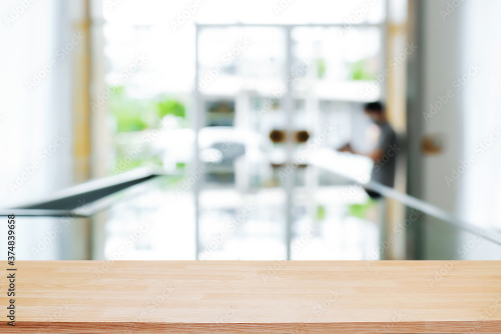 Empty wooden desk space and blurry background of home window for product display montage. Empty wooden desk space and blurry background of home window for product display montage.