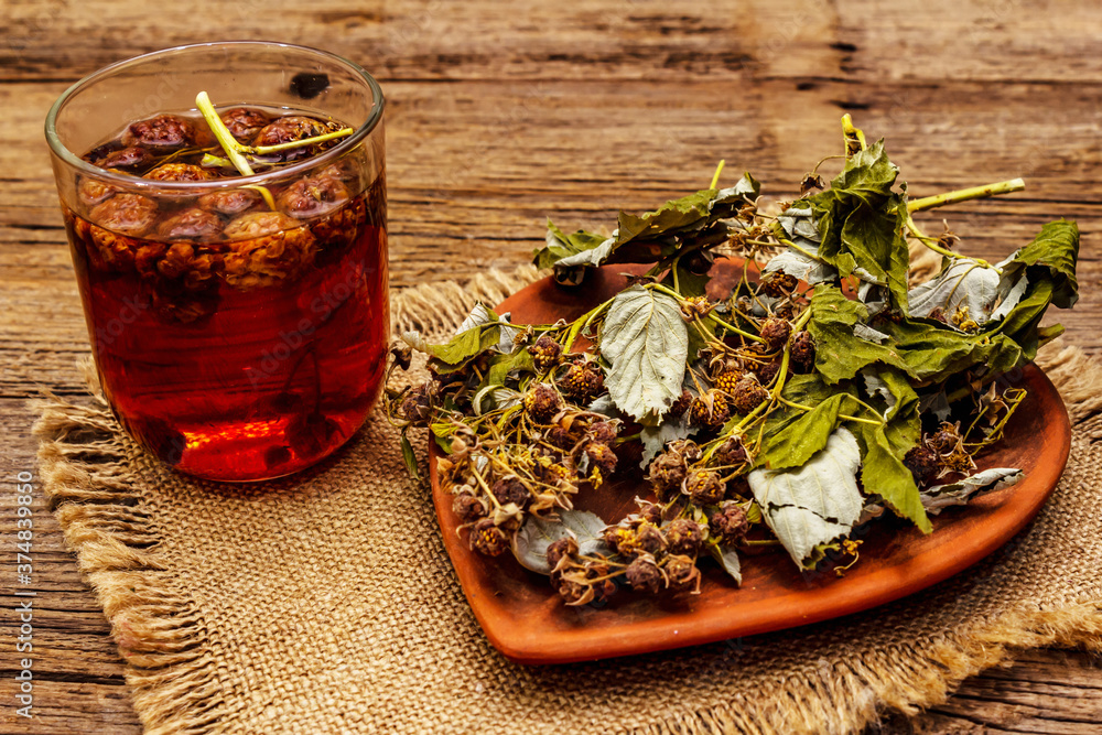 Fototapeta premium Dry leaves, flowers and berries of raspberry for cooking healthy herbal tea