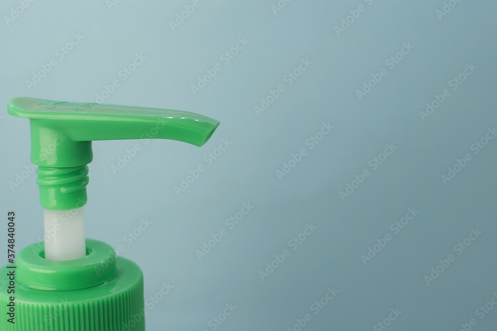 on the left there is a green antibacterial dispenser on a blue background on the right there is free space for text on the left there is a green antibacterial dispenser on a blue background on the right there is free space for text