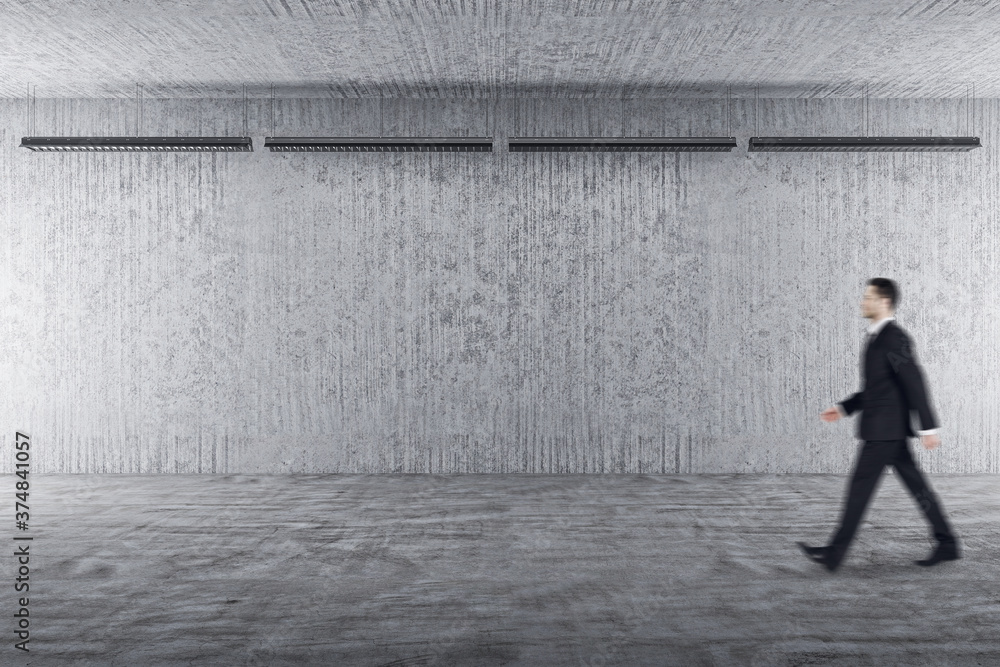Businessman walking in exhibition hall interior Businessman walking in exhibition hall interior