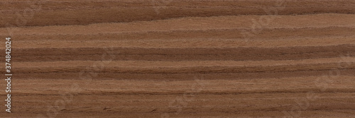 New grey nut veneer background for your interior. Natural wood texture, pattern of a long veneer sheet, plank.
