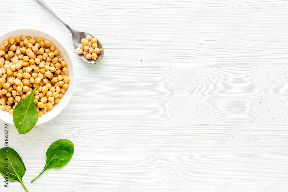 Raw chickpeas in bowl on white kitchen table from above copy space Raw chickpeas in bowl on white kitchen table from above copy space