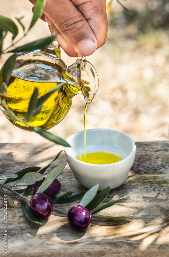 Organic, bio, extra virgin oil and ripe olives in the olive grove. Farmer pours oil into a bowl
Organic, bio, extra virgin oil and ripe olives in the olive grove. Farmer pours oil into a bowl