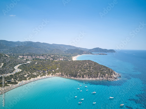 Fototapeta Naklejka Na Ścianę i Meble -  aerial view of sardinia shoreline with boat and crystal clear blue turquoise sea - (Mari pintau - Painted Sea ) TRAVEL in SARDINIA.