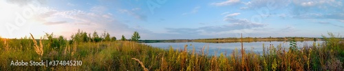Panoramic view of a calm lake on a sunny summer day