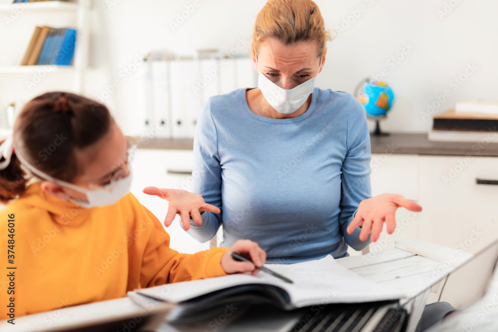 Fototapeta premium Child home studying education, homeschooling, with private tutor / mother with protective mask in the time of viruses, flu and seasonal pandemic, healthy approach in social contact.