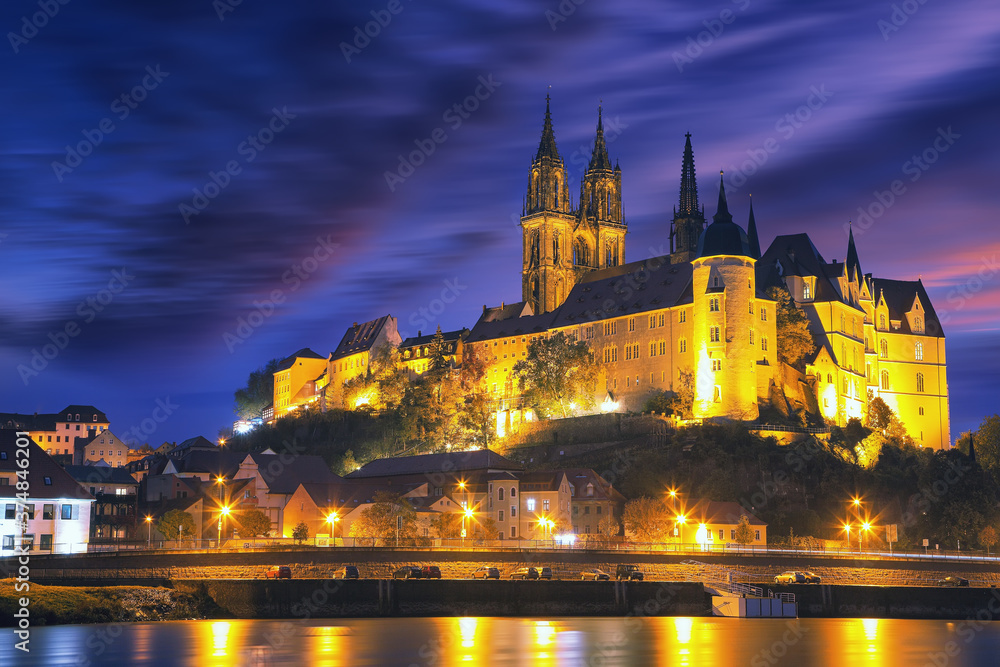 Dramatic view on Albrechtsburg castle and cathedral on the River Elbe during night.