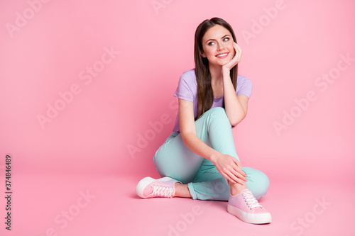Full length photo of attractive charming girl look copyspace sit floor imagine flirt coquette cute guy wear casual style clothes isolated over pink color background
