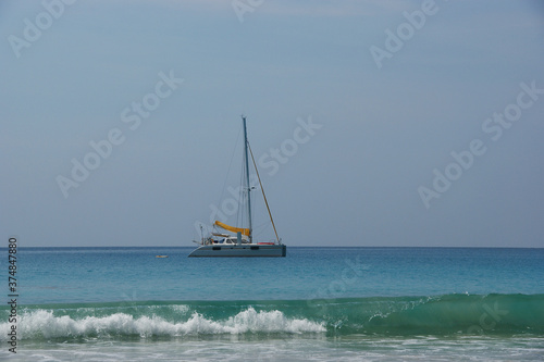 yacht in the ocean. white clean sand and yacht in clear sea water