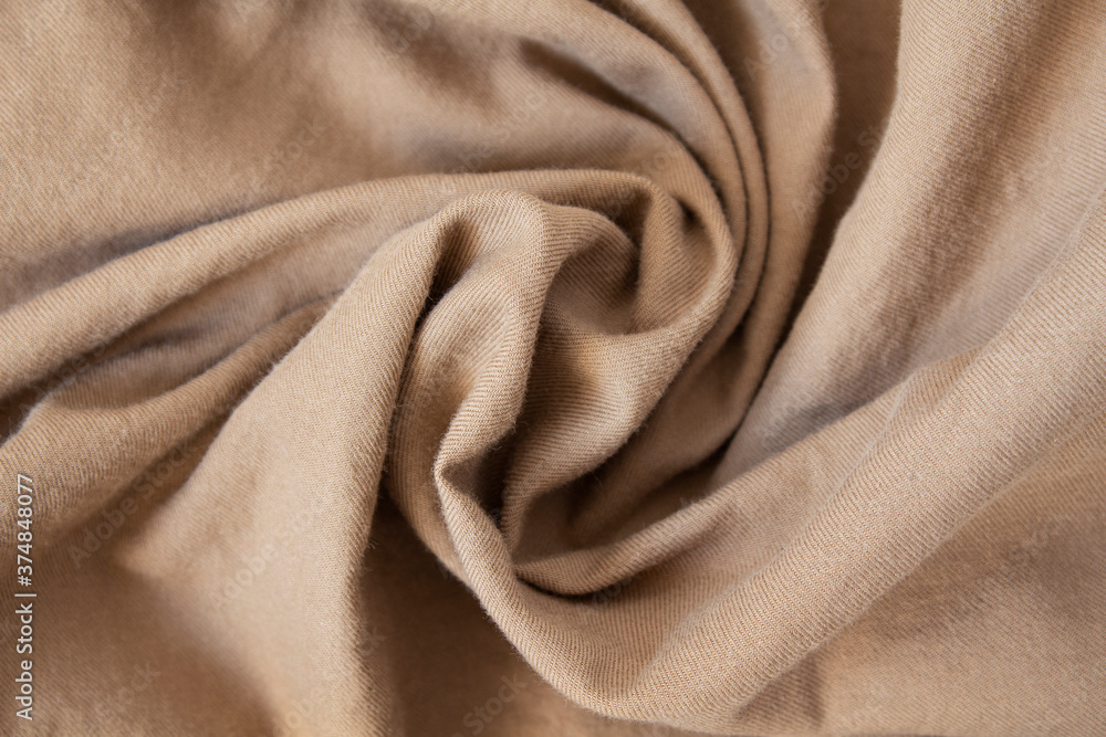 The texture of crumpled beige soft warm fabric. Flannel. The texture of crumpled beige soft warm fabric. Flannel.