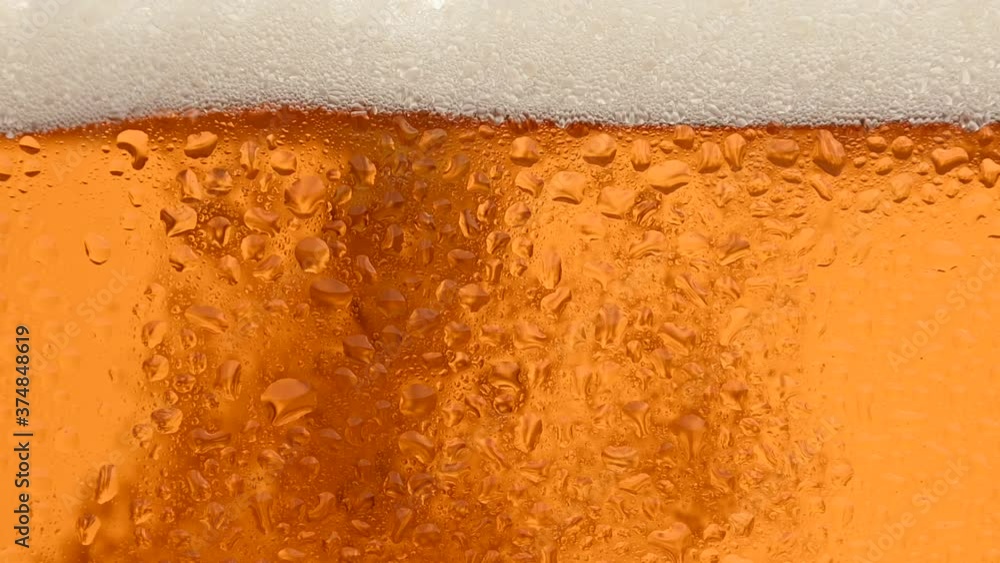 Close up background of beer with bubbles in glass Close up background of beer with bubbles in glass