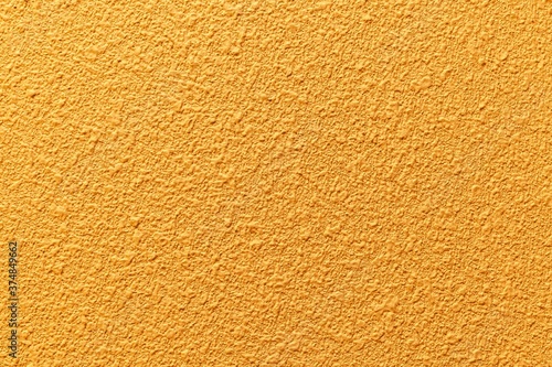 Rough patterned yellow cement wall texture and seamless background