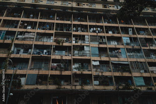 Old apartment building (before 1975) , balconies on a decaying and overcrowded apartment building in Saigon, Vietnam