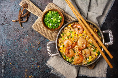 A traditional dish of Asian cuisine. Rice with shrimps, green onion and yellow corn