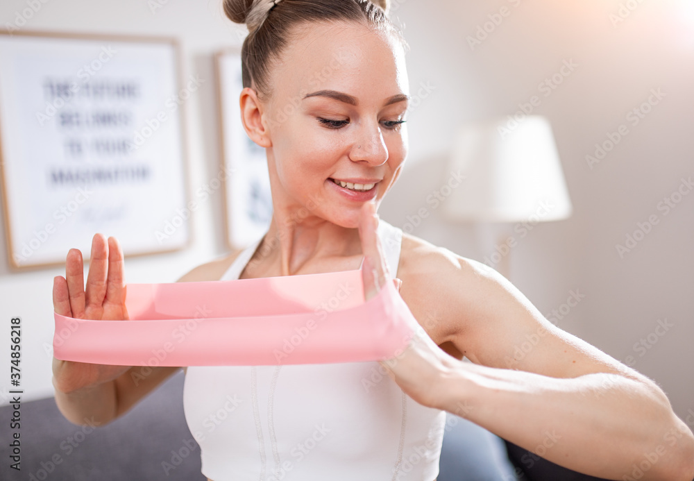 Cheerful woman stretching band during workout Cheerful woman stretching band during workout