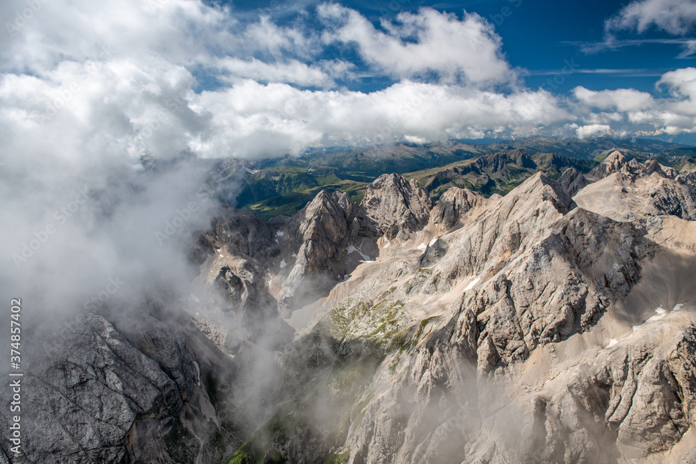 Mountain landscape from Marmolada mountain peak in italian alps against blue sky