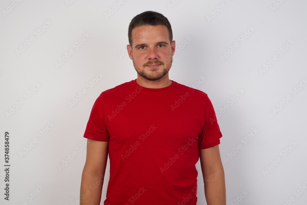 Fototapeta premium Young caucasian man with short hair wearing colorful shirt over isolated white background with a happy and cool smile on face. Lucky person.