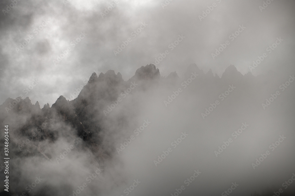 Mountain peaks shrouded by fog and low clouds