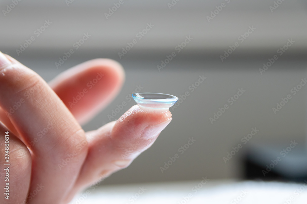 Contact lense on finger to correct nearsightedness and blurred vision eyesight by optician or oculist is to handle with hygiene to correct farsightedness with transparent disposable lense macro Contact lense on finger to correct nearsightedness and blurred vision eyesight by optician or oculist is to handle with hygiene to correct farsightedness with transparent disposable lense macro
