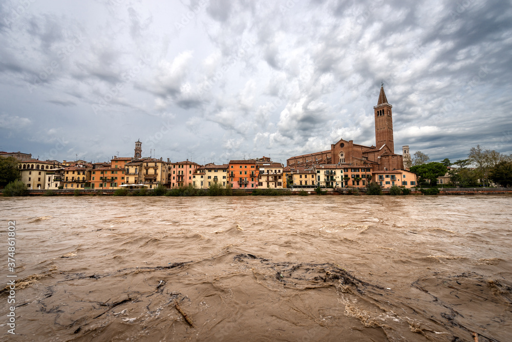 Cityscape of Verona with the church of St. Anastasia (1290-1471) and Adige river in flood after several violent storms. UNESCO world heritage site, Veneto, Italy, Europe