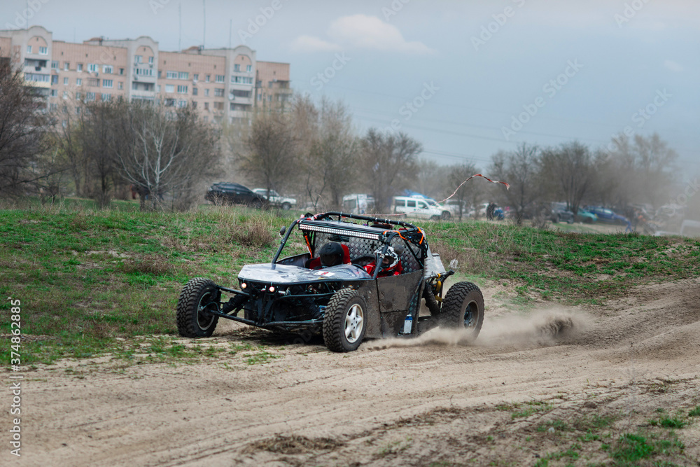 UTV buggy in the action on sand in summer UTV buggy in the action on sand in summer