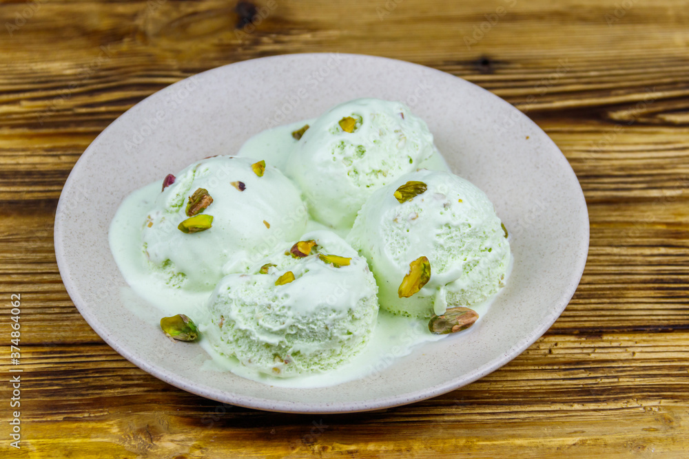 Pistachio ice cream on wooden table Pistachio ice cream on wooden table