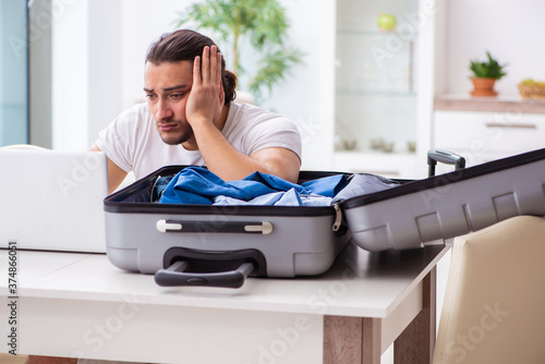 Young man preparing for departure at home photo