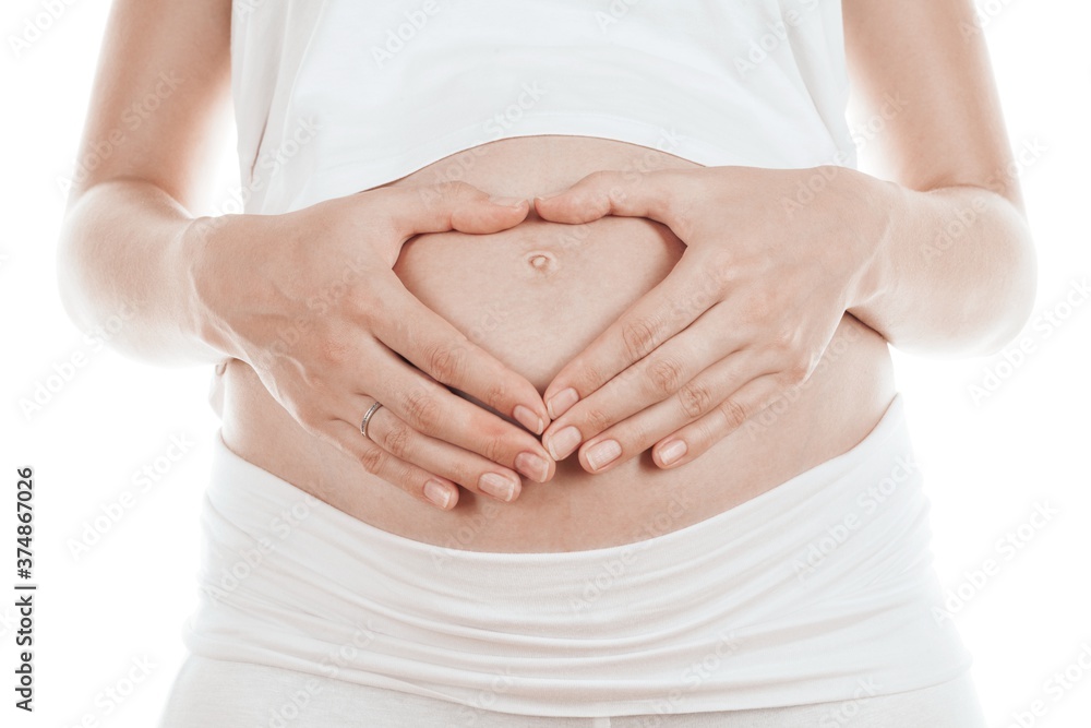 Heart-Shaped Woman Hands on Pregnant Belly Heart-Shaped Woman Hands on Pregnant Belly