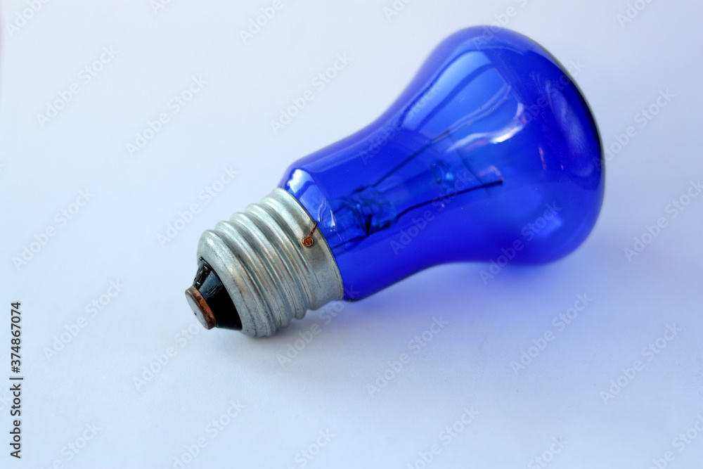 Blue lamp on a white background. Close-up. Horizontal photo. Blue lamp on a white background. Close-up. Horizontal photo.