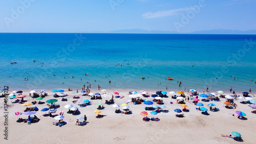 Busy day on the beach. Crowd on the beach on weekend vacation 