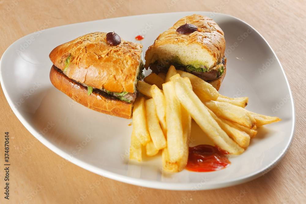 Beef baguette with tomato, lettuce, avocado and dressings accompanied by french fries. Beef baguette with tomato, lettuce, avocado and dressings accompanied by french fries.
