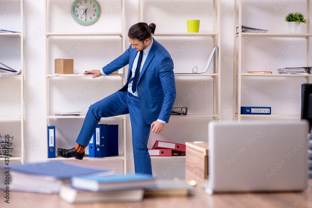 Young male employee unhappy with excessive work Young male employee unhappy with excessive work