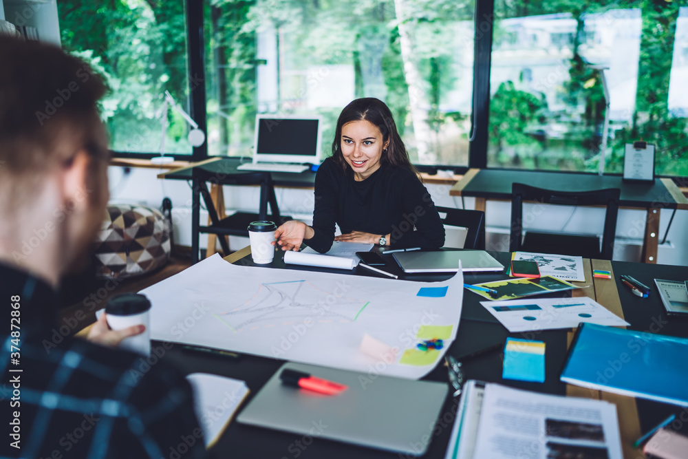 Creative female designer explaining idea to colleague Creative female designer explaining idea to colleague