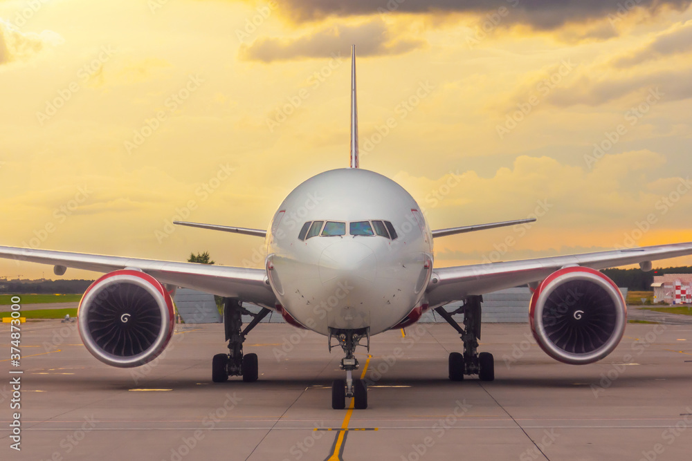 Front view exactly of a wide-body aircraft sunset at the airport. Front view exactly of a wide-body aircraft sunset at the airport.