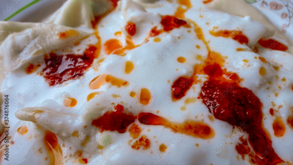 Traditional Turkish cuisine Ravioli, Manti Manlama serving with yogurt and fried butter sauce. Traditional Turkish cuisine Ravioli, Manti Manlama serving with yogurt and fried butter sauce.