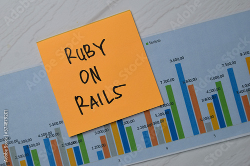 Ruby On Rails write on sticky notes with graphic on the paper isolated on office desk. photo