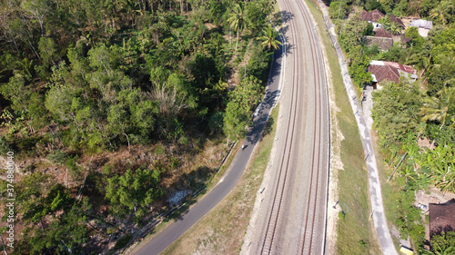 Aerial view of railroad tracks crossing the countryside in Kulonprogo Yogyakarta