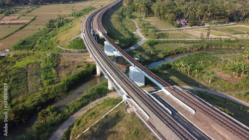aerial view of train tracks across the river. beautiful scenery