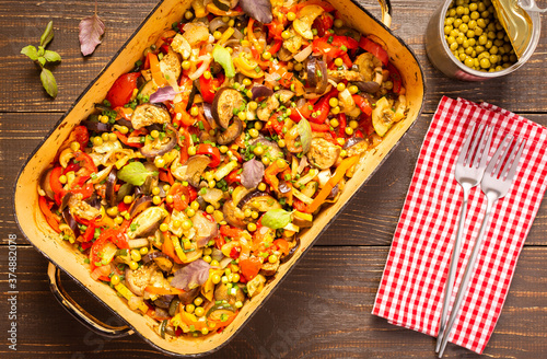 Stewed vegetables in an bowl, eggplant with zucchini and tomatoes, sweet and hot peppers and spices, mixing of Ratatouille ingredients in a bowl photo